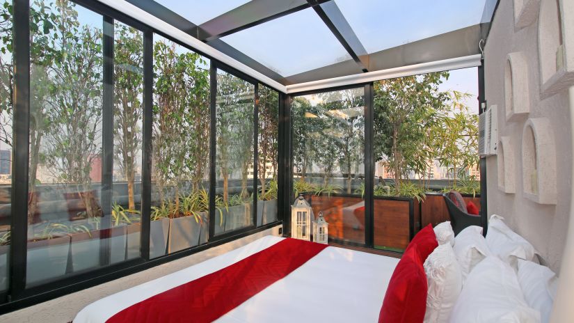 bedroom with glass windows at theory9 bandra