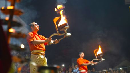 Priest performing aarti with diyas