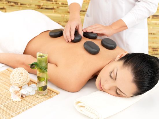 A woman getting a hot stone treatment done 3