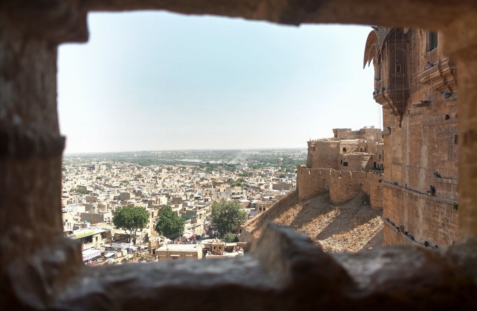 View of Jaipur through a gap in the wall of a fort