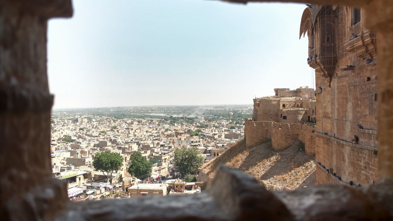 View of Jaipur through a gap in the wall of a fort