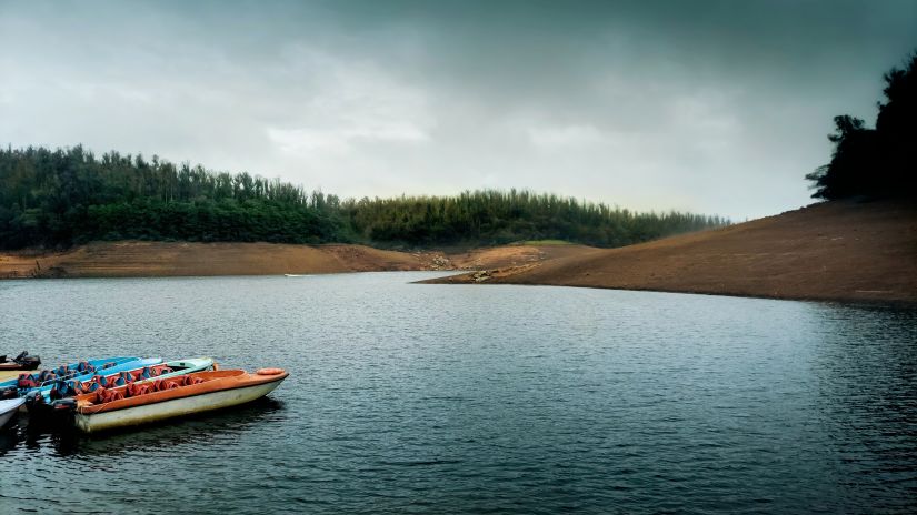 a view of Pykara Lake with a boat in the water