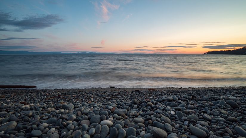 an overview of a beach with rocks on the shores and the evening sky after the sun set - Places to visit in Port Blair