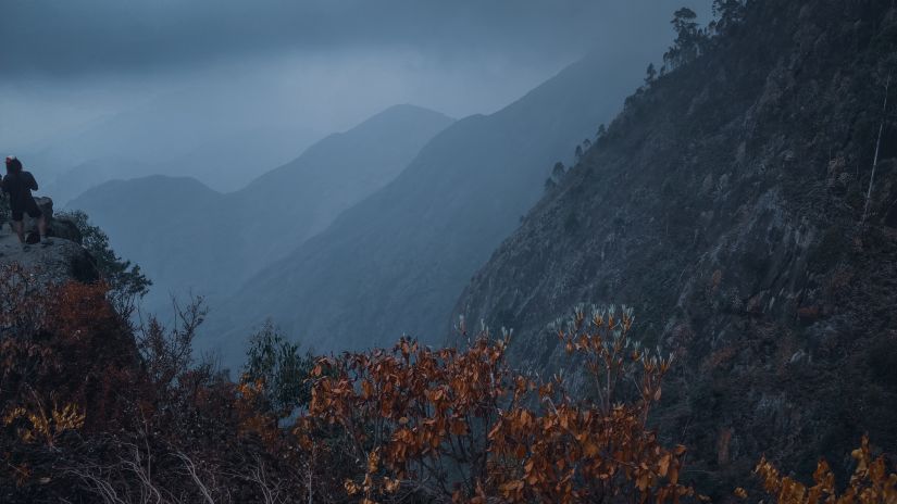 a foggy view of a hills in the distance