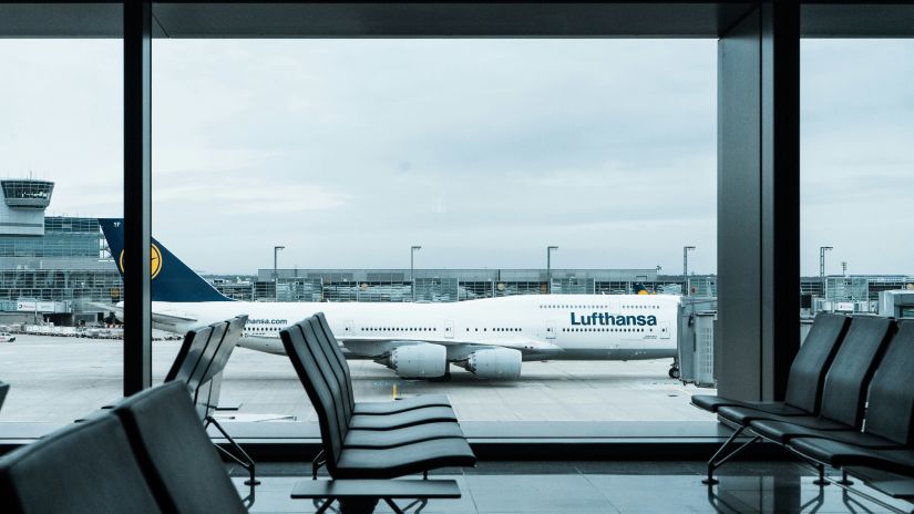 an overview of the waiting area for flights with an aeroplane in the background