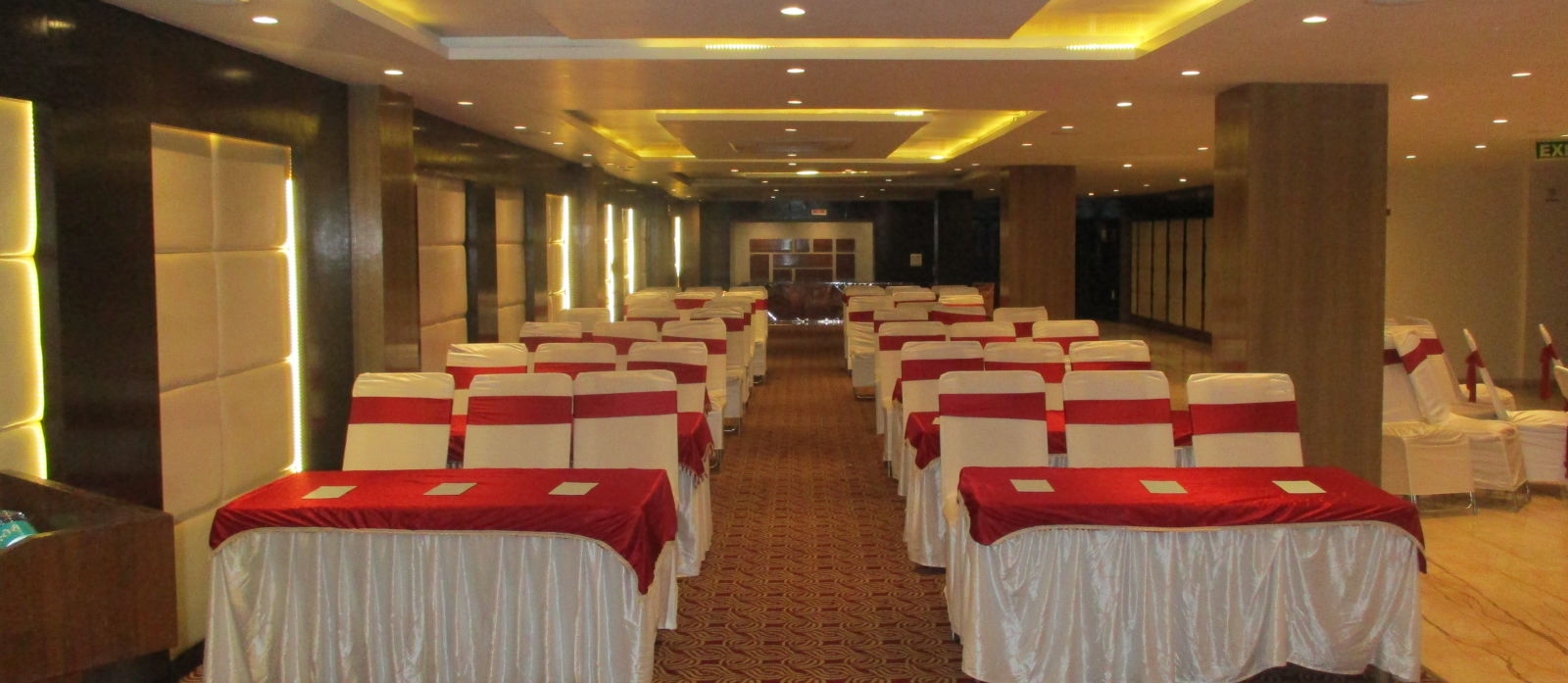 a spacious conference hall with theatre style seating at le roi raipur hotel