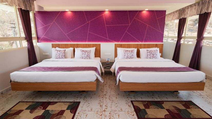 a bedroom with two king size beds side by side - MGM Whispering Wind's, Yelagiri