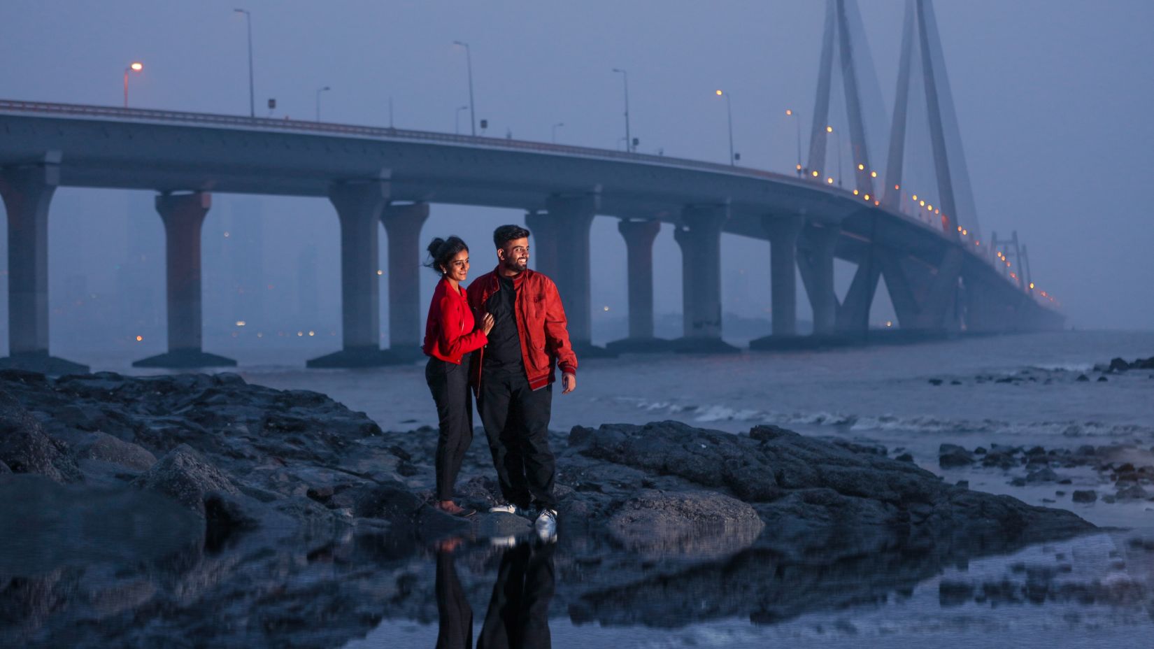 couple standing under the bridge