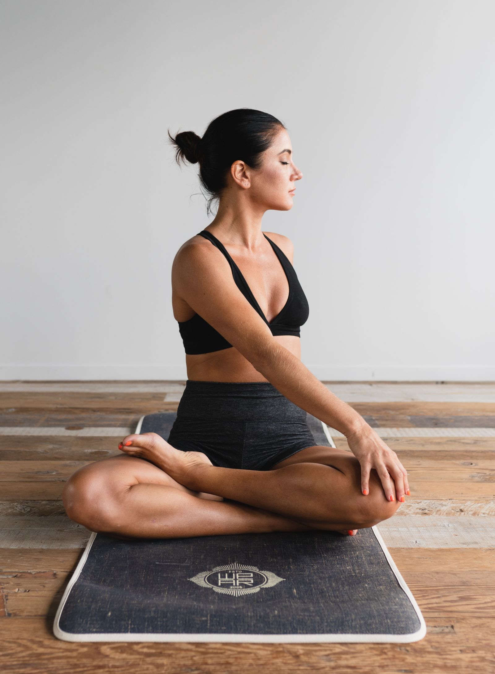 A woman practicing yoga on a mat - Monsoon and ayurveda - gamyam Retreat