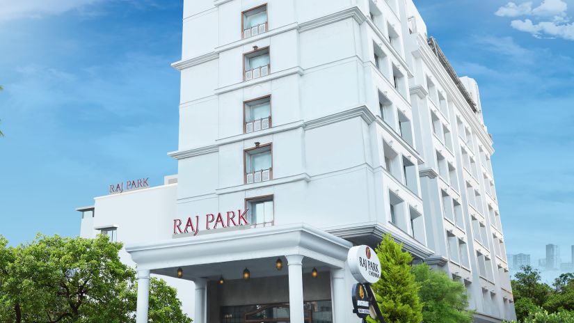 facade of Raj Park in the morning with blue sky in the background - Raj Park Hotel, Chennai