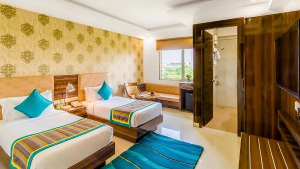 Image of Deluxe Twin Room featuring twin beds, sofa and a TV | Inde Hotel Cyber City