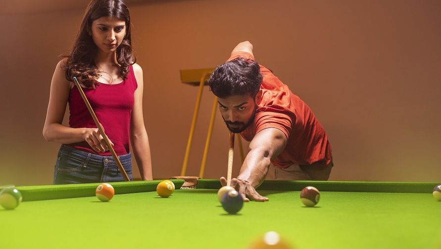 A couple shooting pool