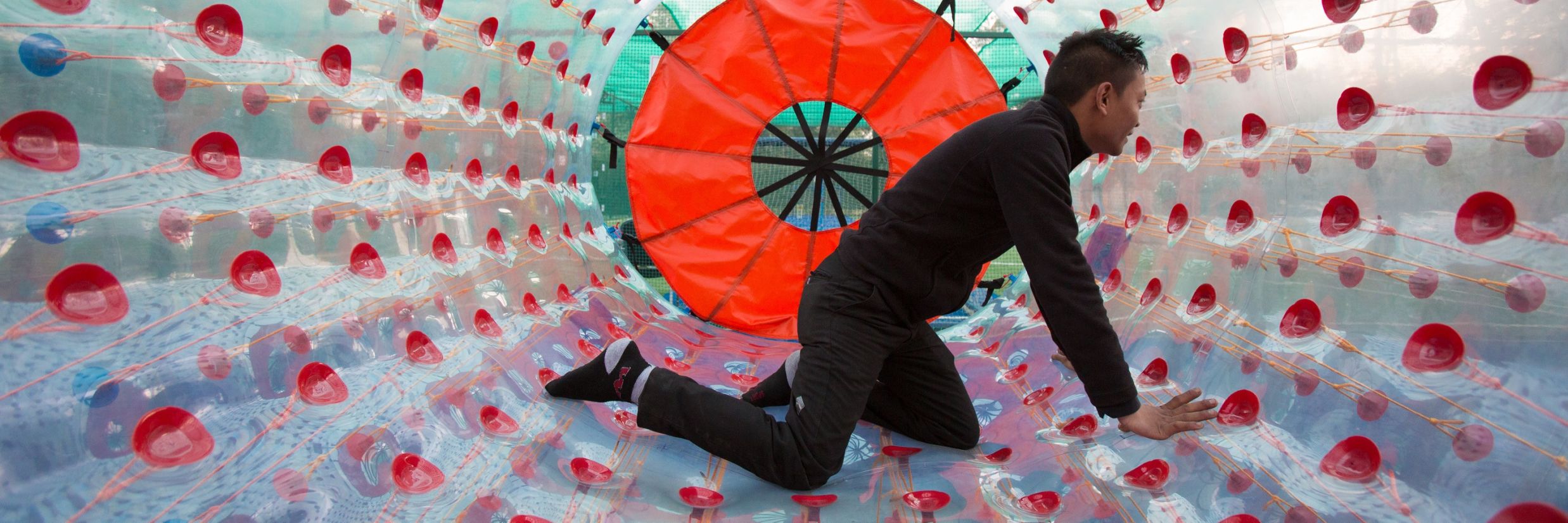 Man enjoying doing adventure activity in a big ball