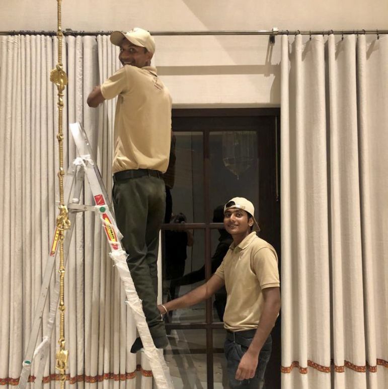 Man climbing a ladder to arrange decoration