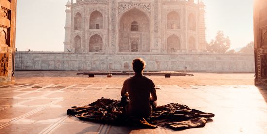 alt-text A women watching the grand Taj Mahal