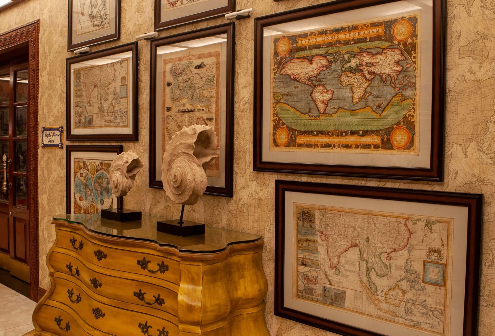 a wall filled with map images - best resort in gopalpur- Mayfair Palm Beach Resort, Gopalpur-on-Sea