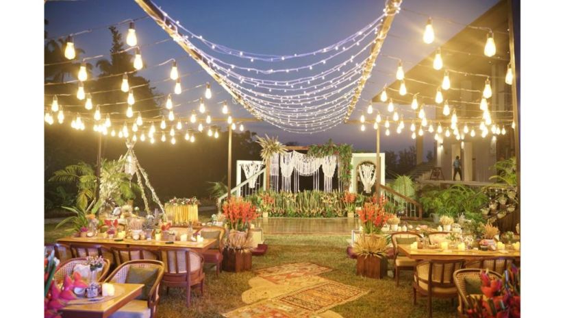 an outdoor event area all lit up with lights and decorated with flowers for an event at Symphony Samudra Beachside Jungle Resort And Spa, Port Blair