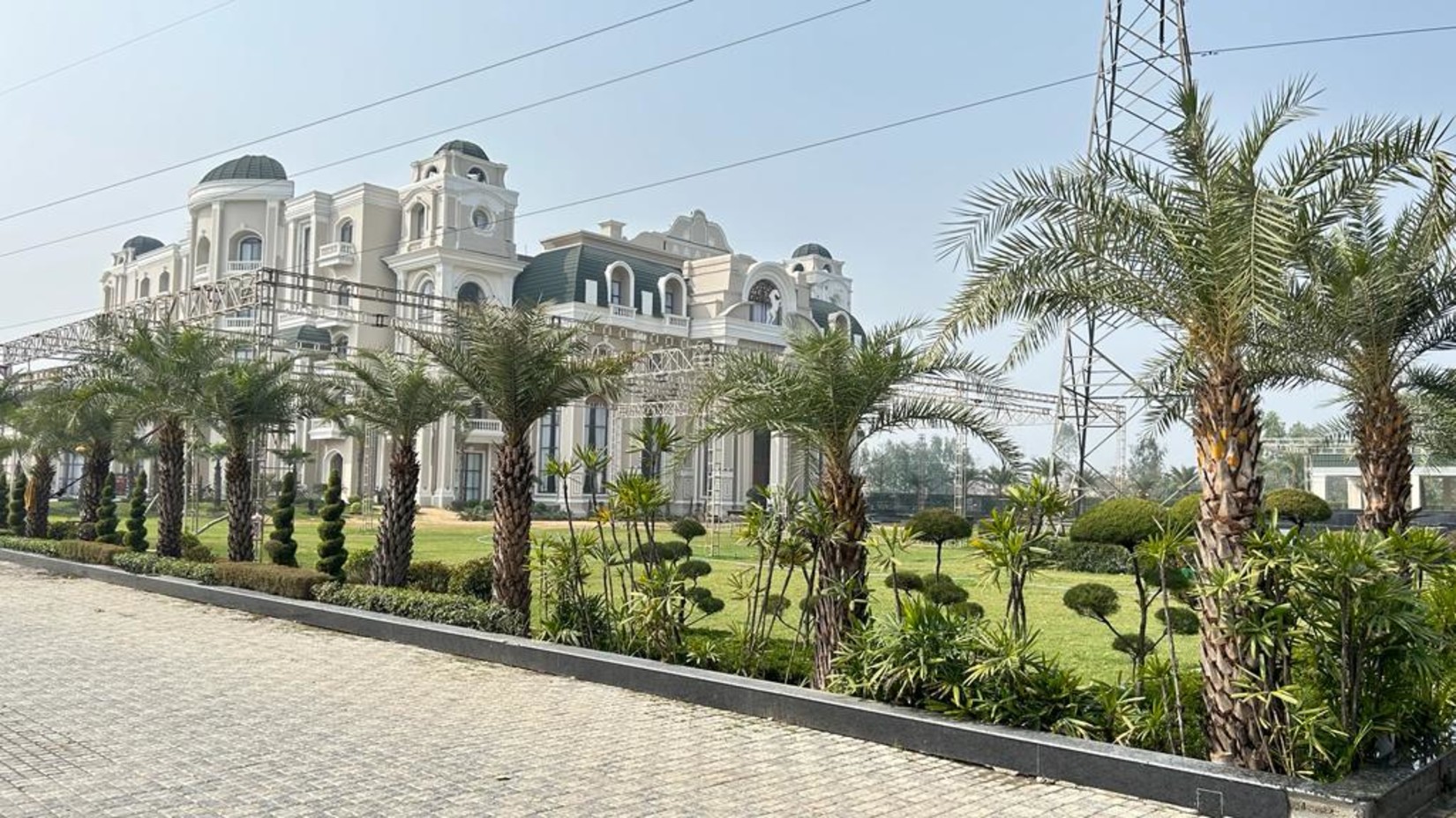 a view of the facade of the property with trees lined up along the border of the property - Sarovar Portico, Saharanpur