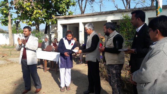 A girl getting a prize for an event at Golden Tusk