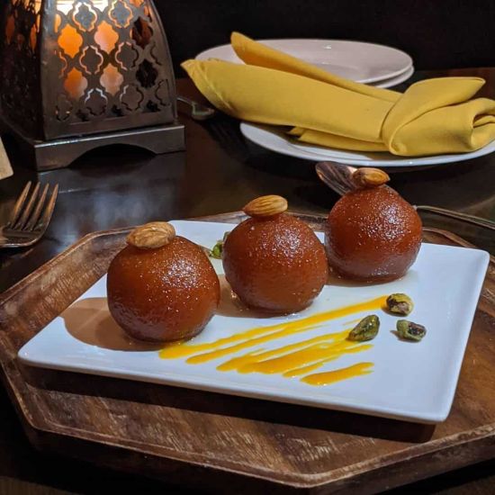 Three gulab jamuns served on a plate | Sun Park Hotel & Banquet, Chandigarh - Zirakpur