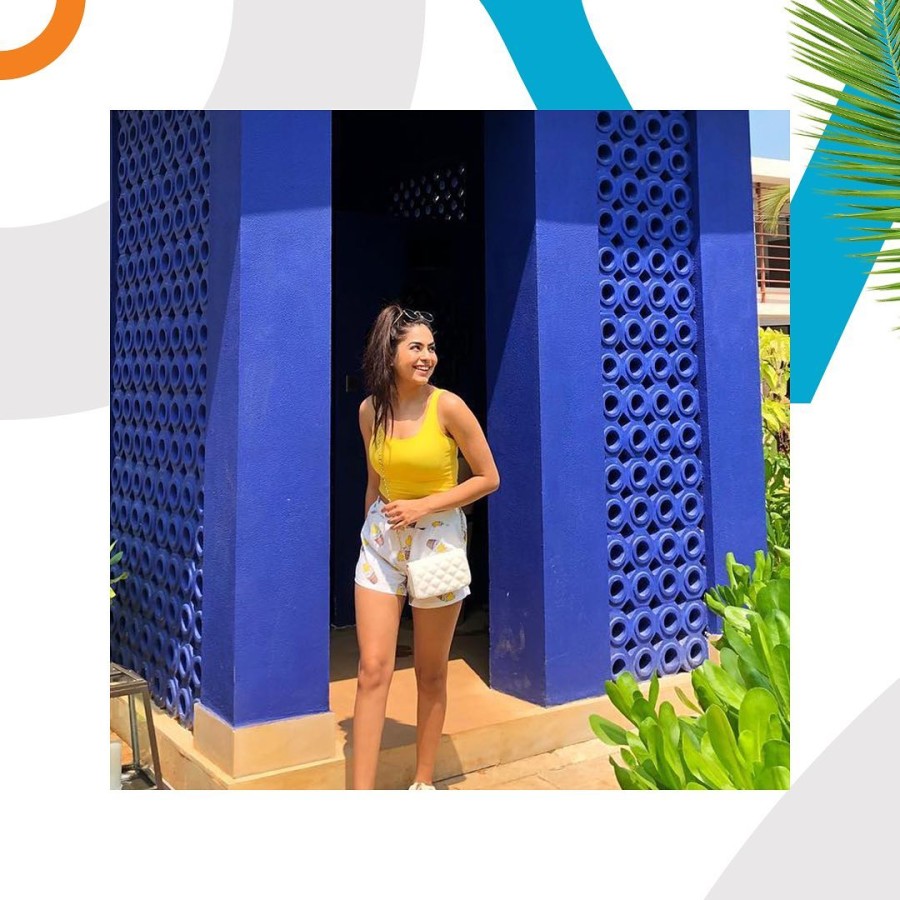 Woman with a yellow top smiling while staying at our South Goa resort