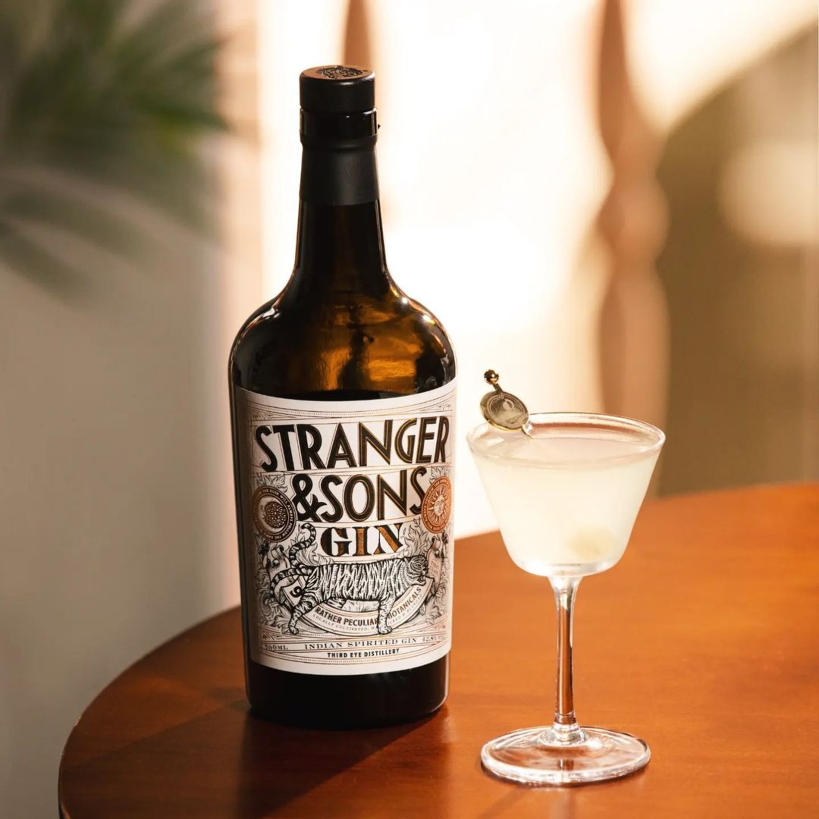 a bottle of Stranger and Sons kept on a table - Villa in Palms by V Escapes