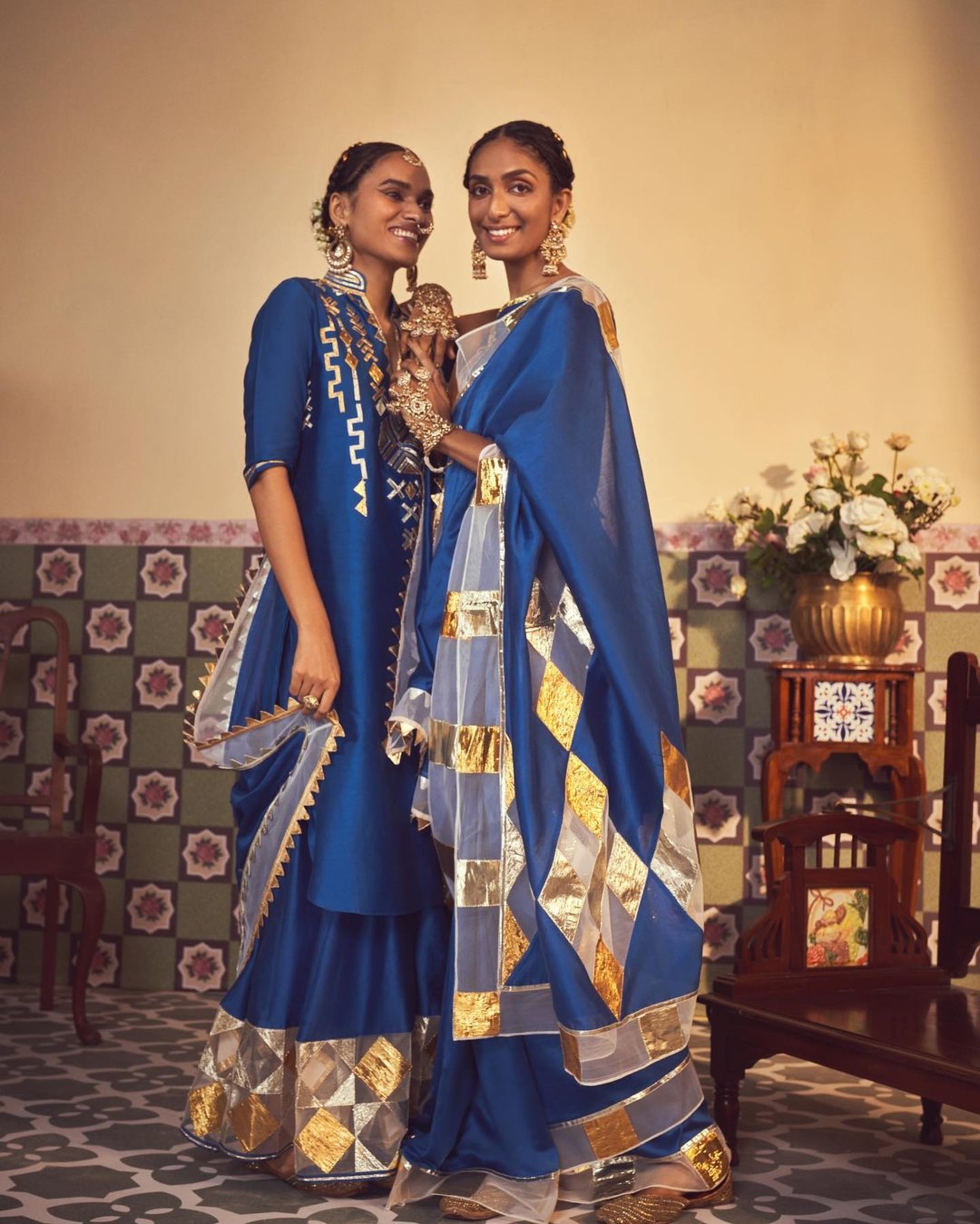 2 women wearing blue sarees