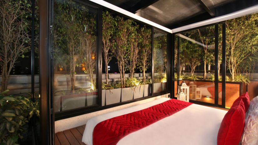 bedroom with glass doors and magnificent views in mumbai at theory9