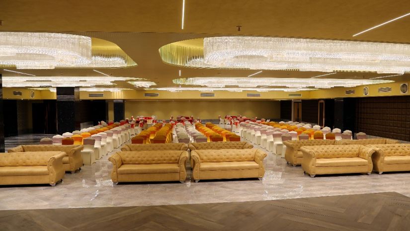 Theatre style seating arrangements inside the banquet hall with modern lights on the ceiling - VITS Bharat Nanded