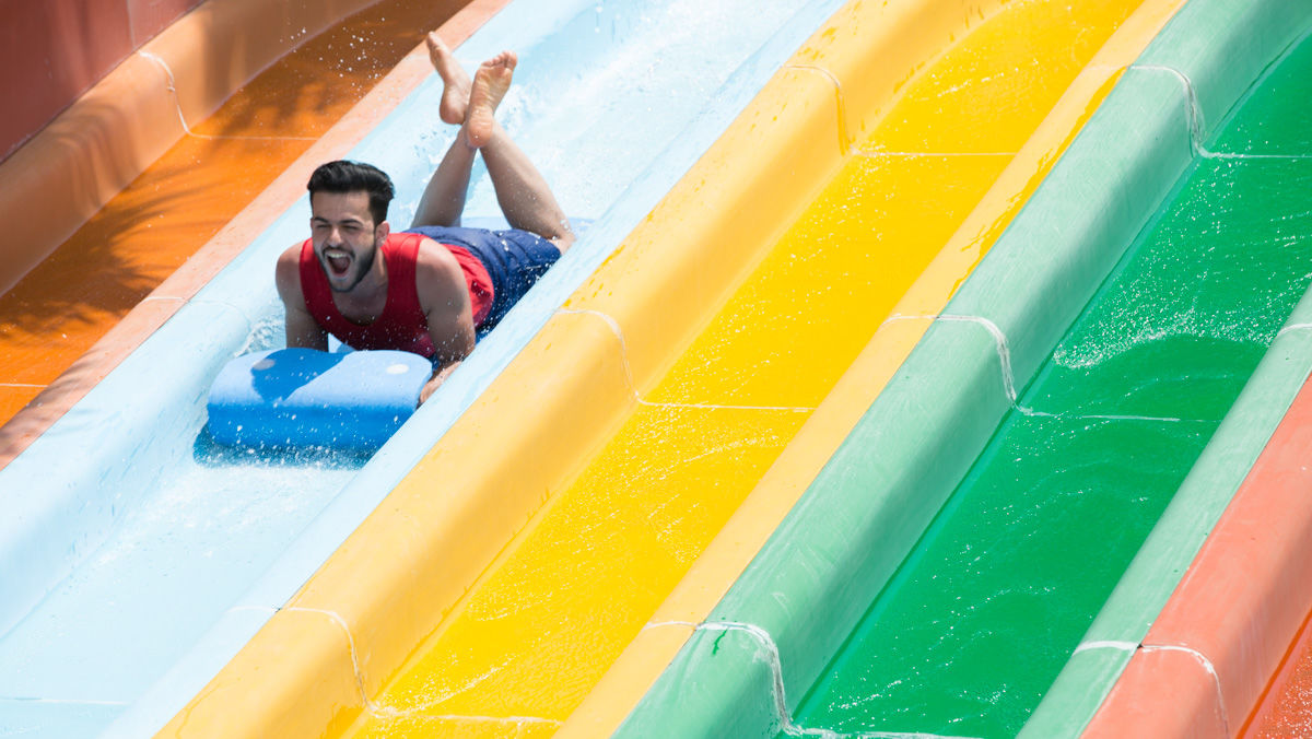 Man sliding down a water slide