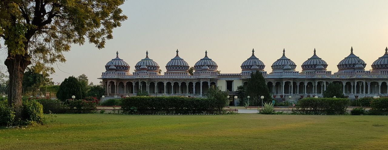 a temple in Bhilwara featuring a lawn during dayitime