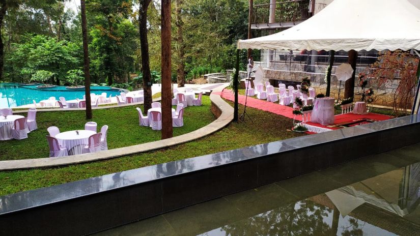 The Birchwood Retreat - Image of a lwan containing a canopy and chairs facing the property s swimming pool