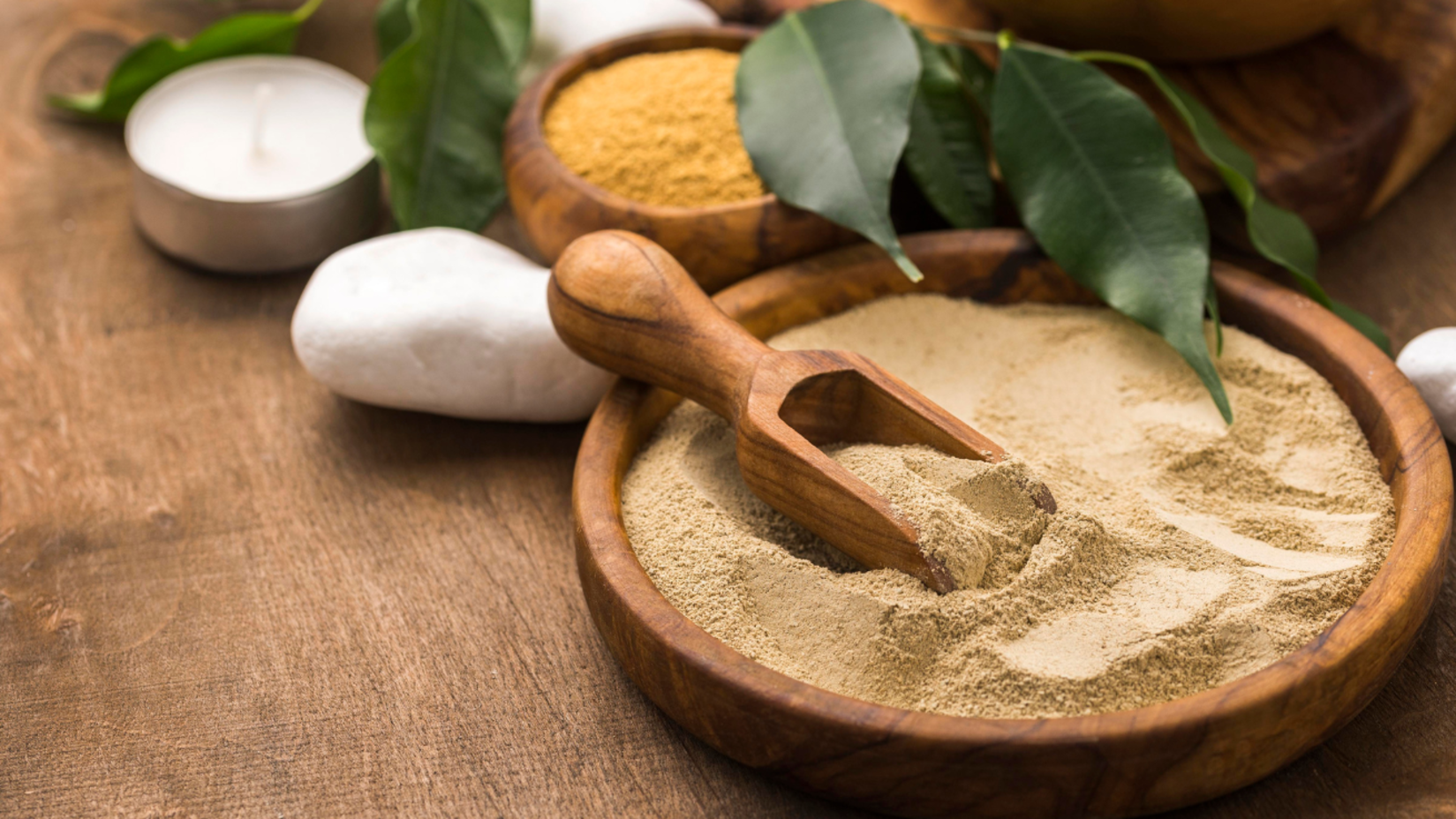 Tibetan body scrub on a tray with a white stone near a plant.