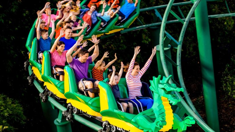 a group of people sitting in a roller coaster enjoying the ride - Black Thunder, Coimbatore