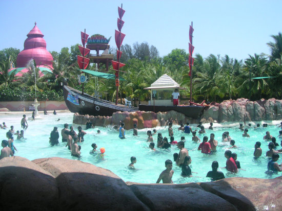 alt-text Water Kingdom - multiple groups of people playing at the jungle beach boat during daytime