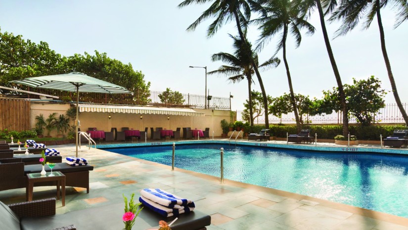 poolside patio at Ramada Plaza Palm Grove - Hotels with swimming pool in Mumbai