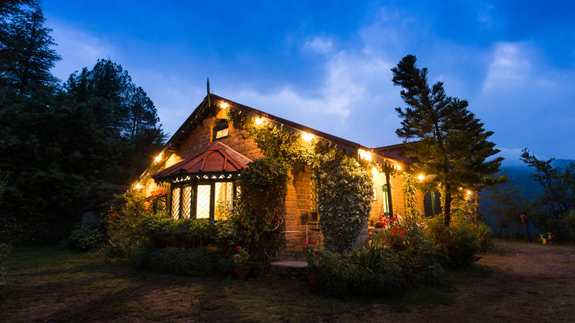 The Ramgarh Bungalows - exterior of a bungalow with dim lights during sunset