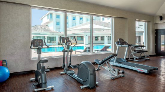 an image of a well-equipped gym at The Residency Towers, Rameswaram