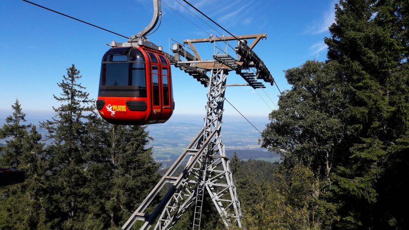 a cable car against the backdrop of a hill station