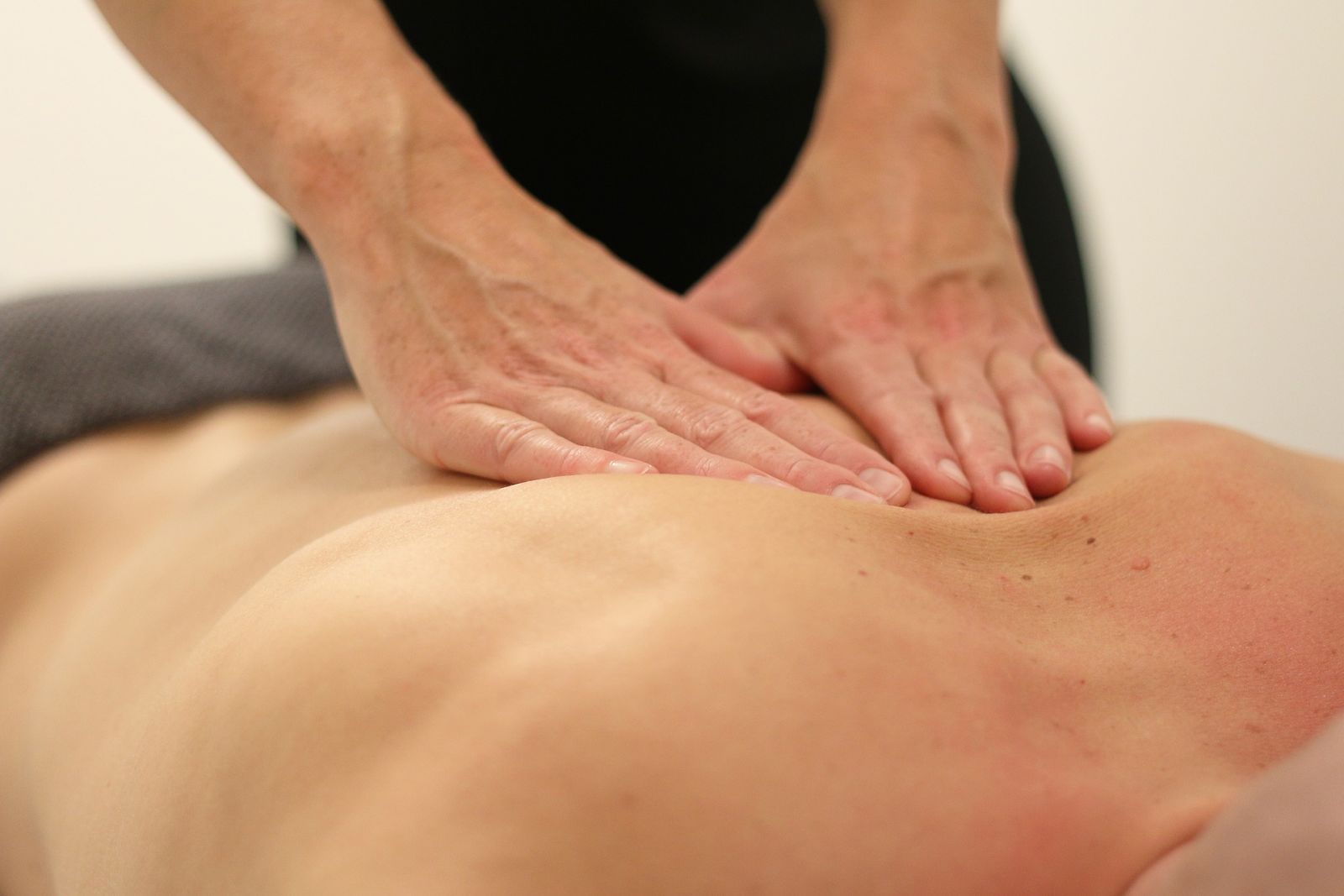 a therapist providing a massage to a client 2