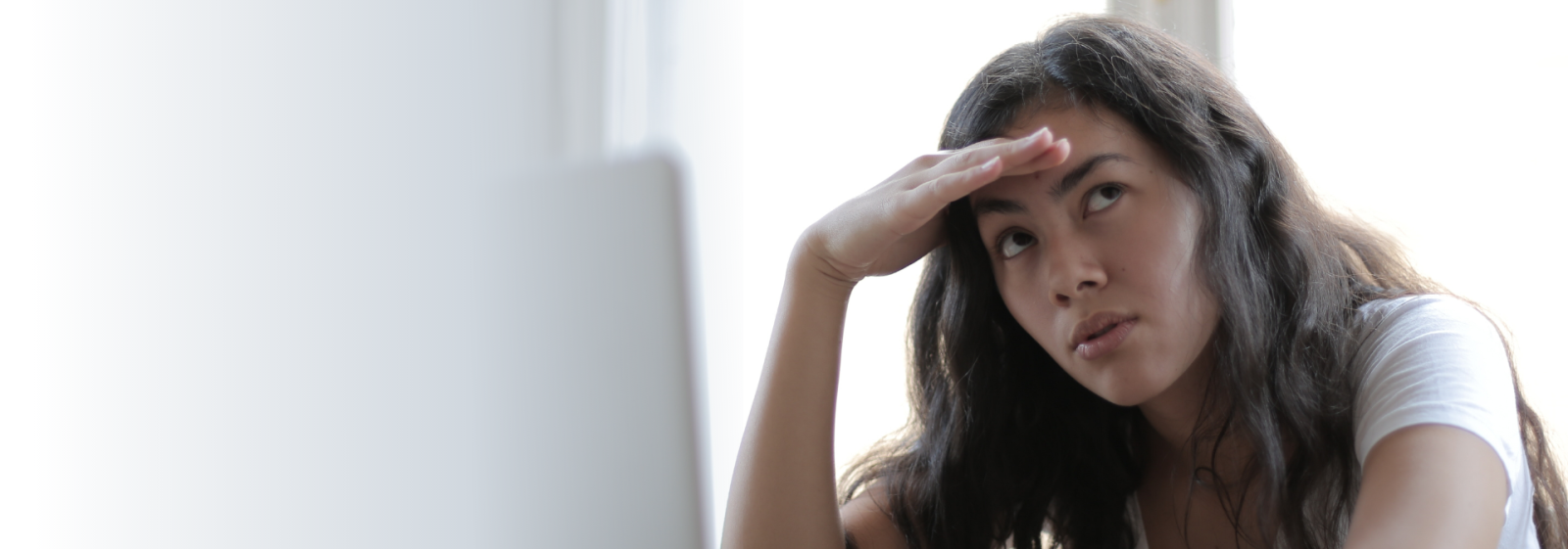 A young lady in despair after answering phone queries.