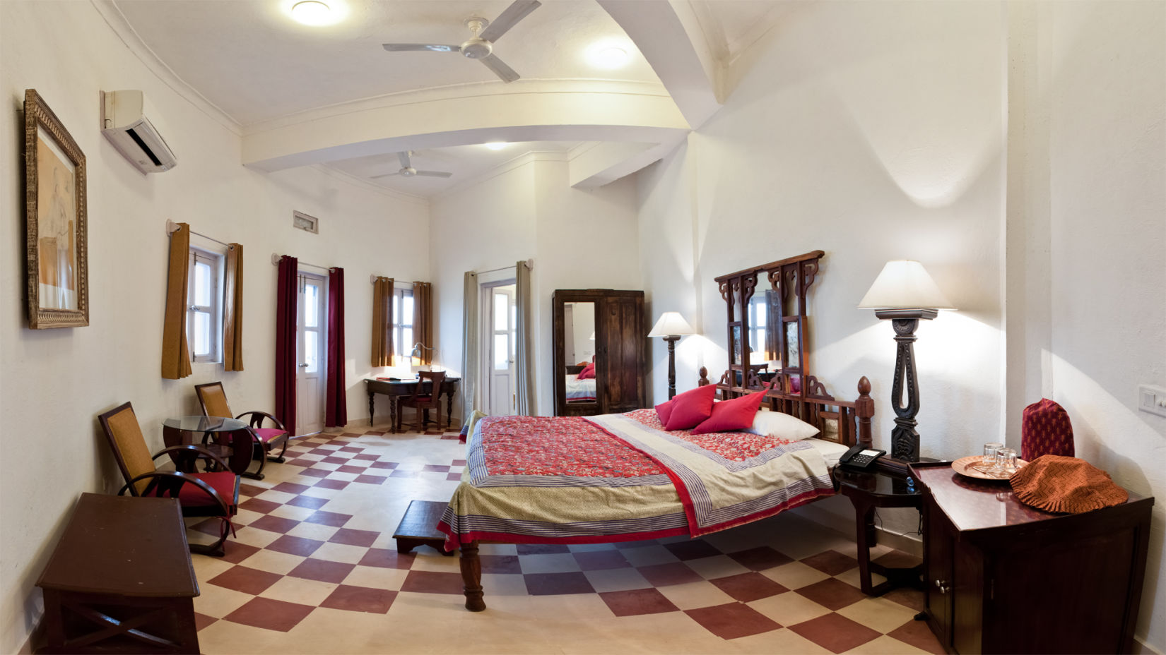 Hill Fort Kesroli 14th Century Alwar - interior view of the Narendra Burj with a king size bed and checkered floors