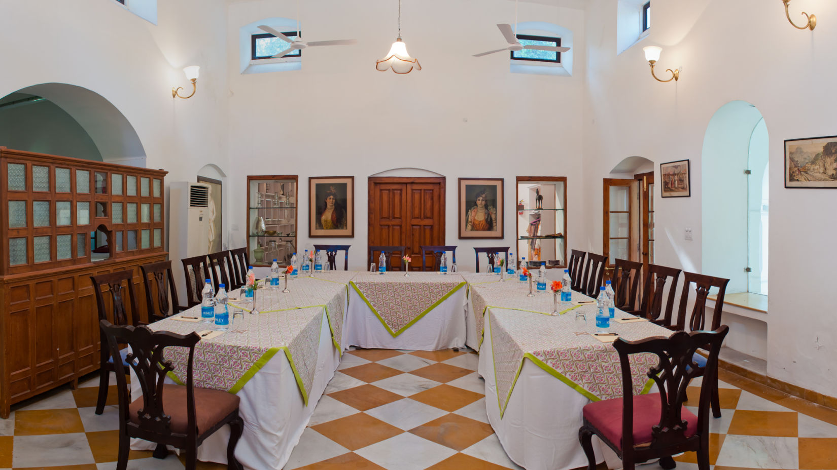 U Shaped seating with chairs and water bottles on the table - The baradari palace