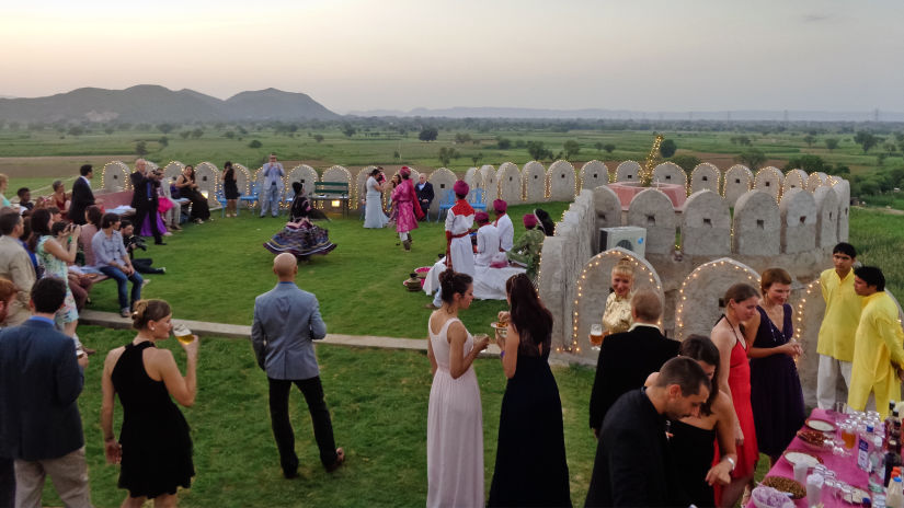 Image of people gathered on a lawn area - Resort for marriage