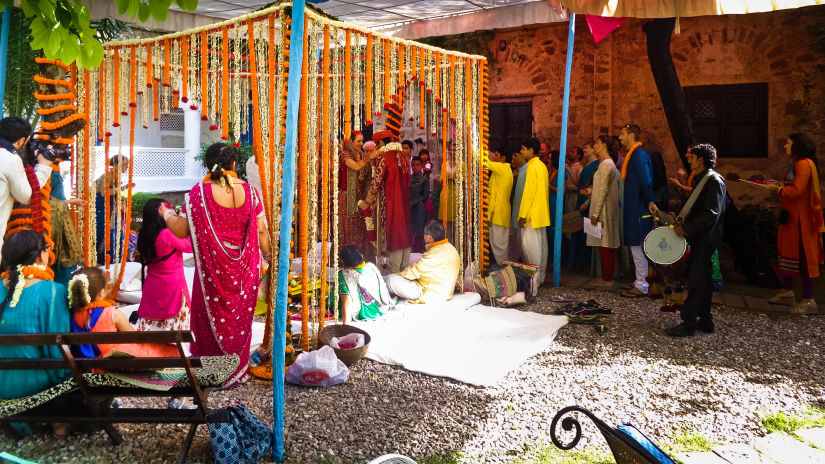 Hill Fort Kesroli 14th Century Alwar - Image of an outdoor banquet space adorned with flowers where people have gathered in traditional Indian attire