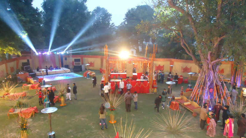 an aerial view of the garden with food counters and the stage during a wedding - The Baradari Palace