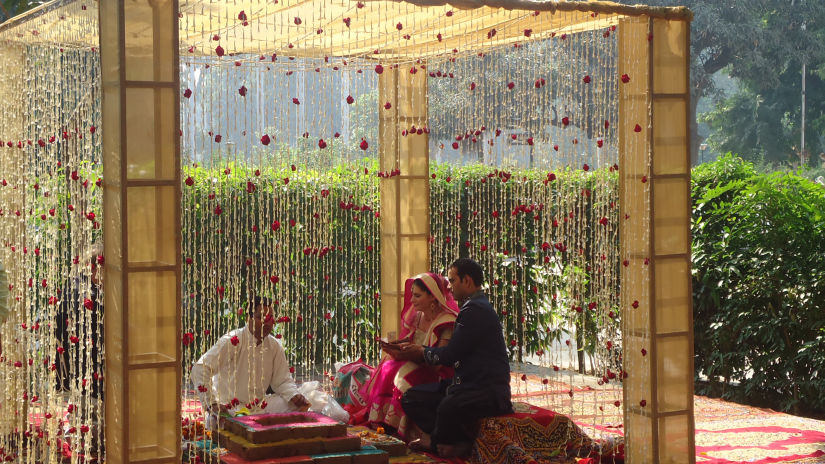 a couple performing rituals during the marriage ceremony - The Baradari Palace