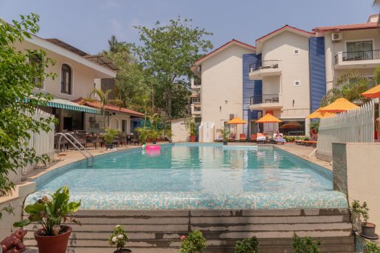 alt-text Pool surrounded by buildings at Kyriad Prestige Calangute, Goa
