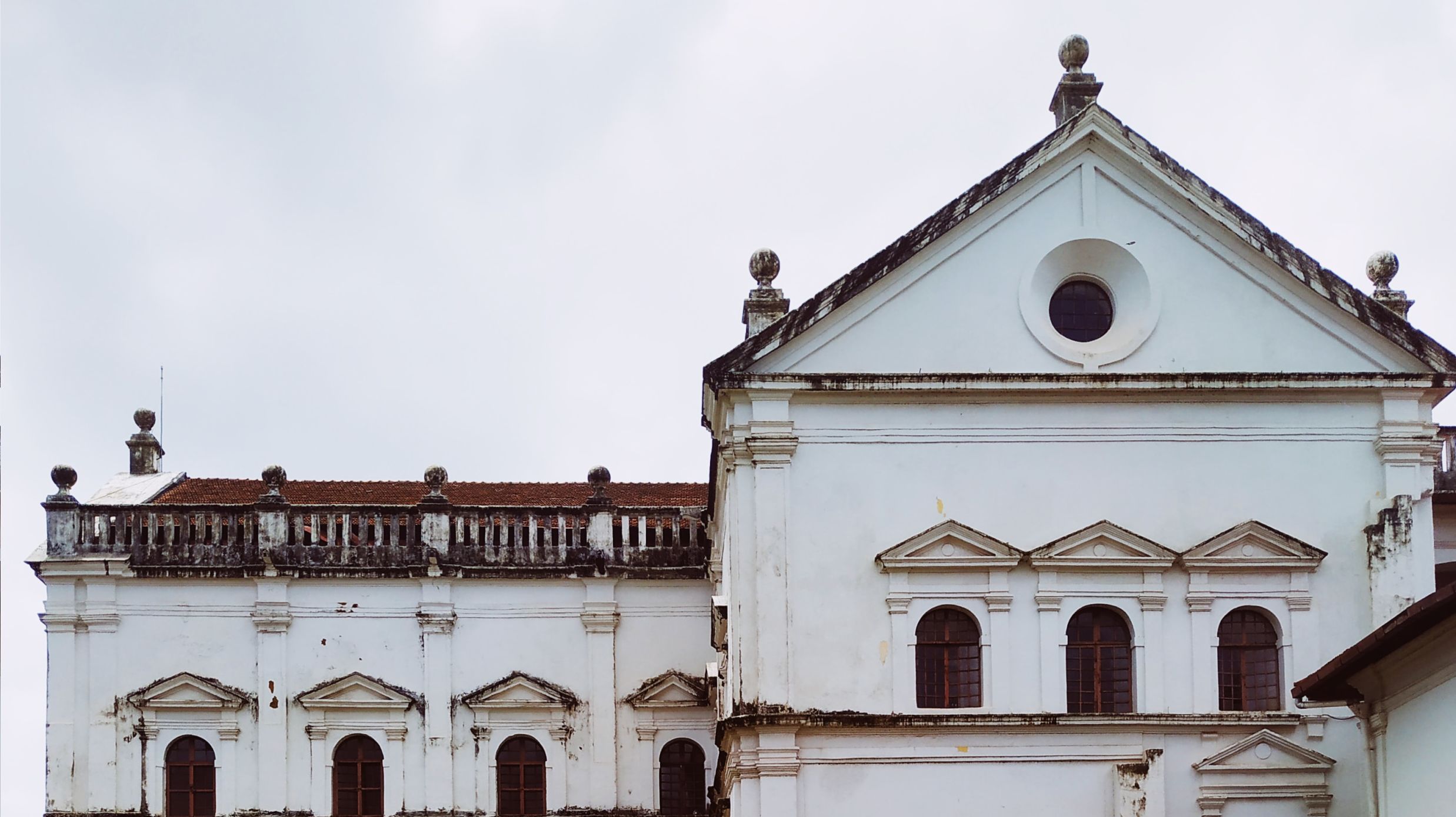 Exterior of Se Cathedral in Goa with a green lawn @ Lamrin Ucassaim Hotel, Goa