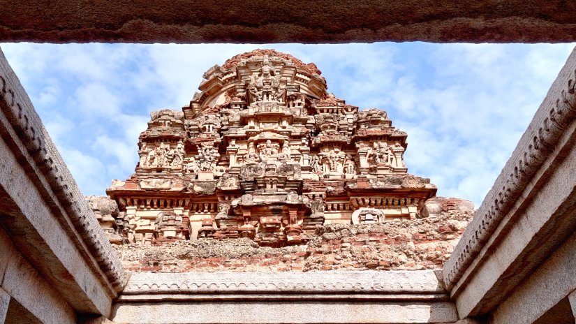 A temple dome with intricate carvings viewed from bottom